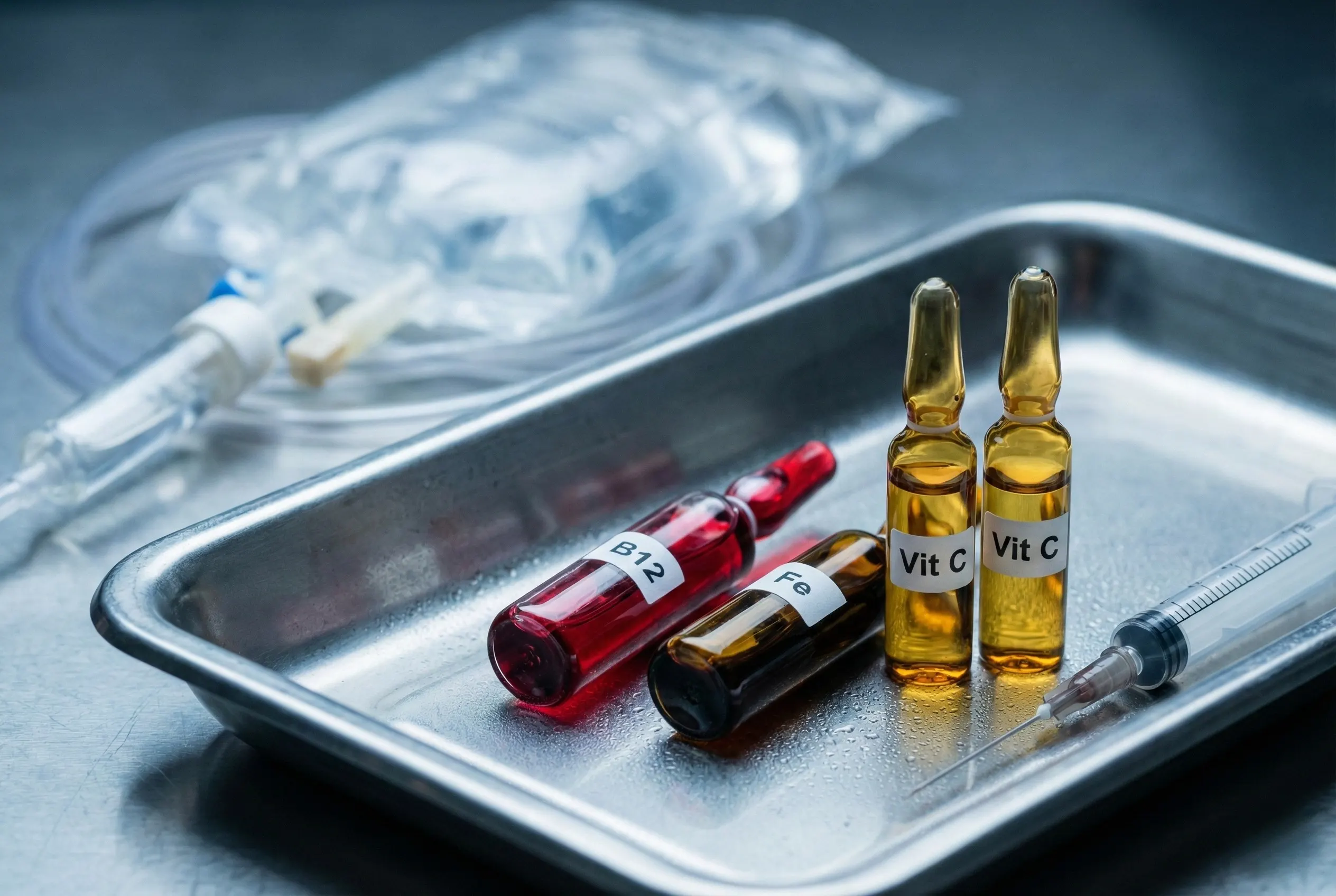 Bandeja médica contendo ampolas de vitaminas (B12, Vitamina C, Ferro) utilizadas nos protocolos de soroterapia endovenosa da Dra. Karen Lima em Samambaia Sul.